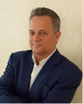 A man in a suit and tie posing for the camera.